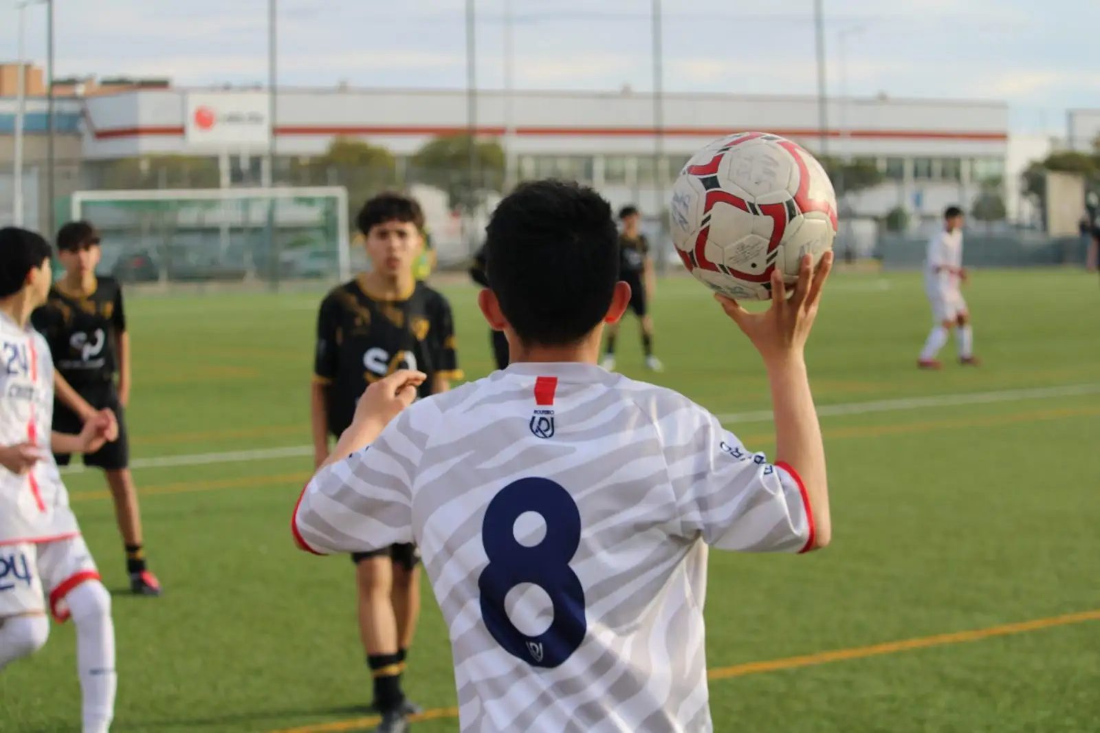 Young players celebrating at a TSG youth football tournament in Madrid.